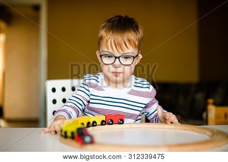 Little Ginger Boy With Glasses With Syndrome Dawn Playing