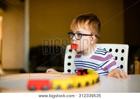 Little Ginger Boy With Glasses With Syndrome Dawn Playing