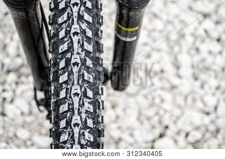Image Of The Front Wheel Of The Bicycle Close-up After A Ride On The Rocks