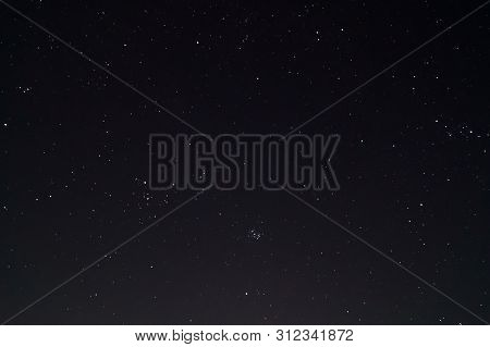 Underexposed Night Sky Low Light Photo. A Lot Of Stars And Constellations On Dark Sky. Stock Photo O