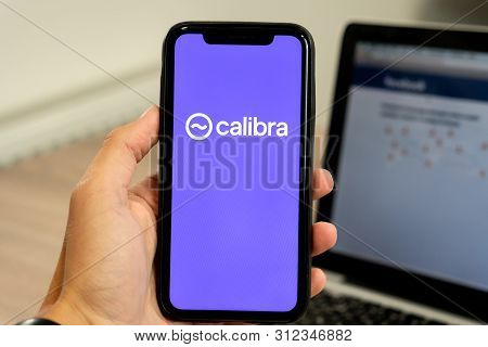 12 July 2019, Ljubljana Slovenia - Hand Holding Smartphone With Calibra Logo On It. Facebooks New Gl