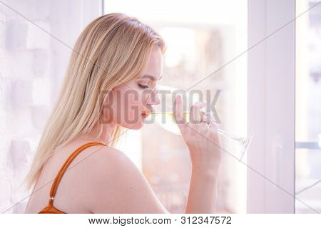 Pretty Plus Size Caucasian Woman Drink Wine In The Morning Alone At Home