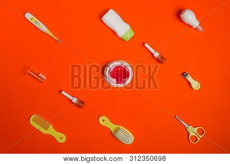 Baby Healthcare Accessories With Pediatric Micro-enemas On Red Background
