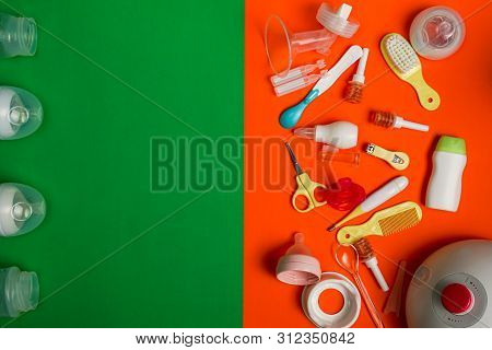 Newborn Care And Breastfeeding Accessories On Green And Orange Background