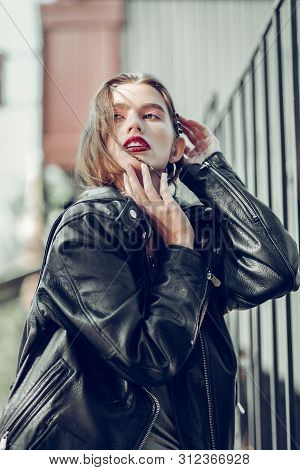 Languid Appealing Woman With Red Lips Touching Her Face