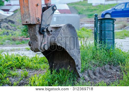 Excavator Tool Close Up Shot On Street Construcion Site At Early Morning.