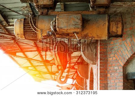 Electric Windlass With Hook For Lifting Large Loads. Against The Sky