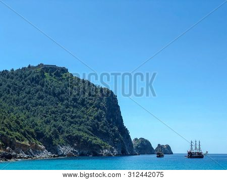 View Of The Fortress On The Mountain And The Ships On The Mediterranean Sea.
