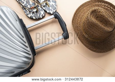Flat Lay Grey Suitcase With Brown Hat And Sandles On Pastel Background. Travel Concept - Image
