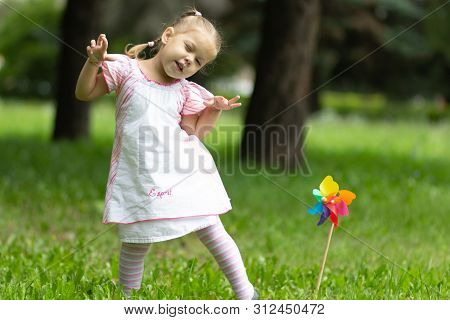Child Playing The Ape In The Summer Park