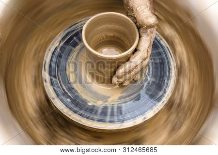 Potter's Hand Mold Pottery On A Rotating Wheel