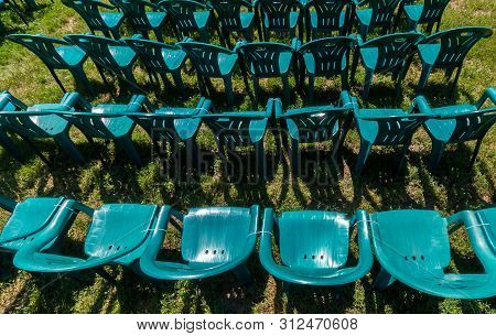 Bucharest, Romania - June 23, 2019: Green Plastic Chairs Are Placed In Izvor Park For Spectators Who