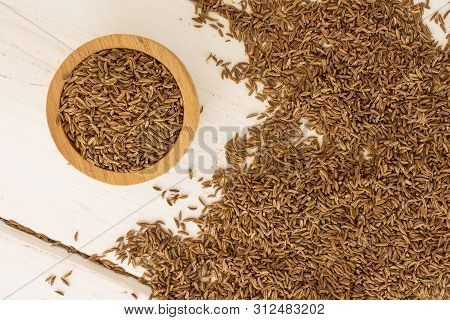 Lot Of Whole Sharp Dry Caraway Fruits In A Wooden Bowl Flatlay On White Wood