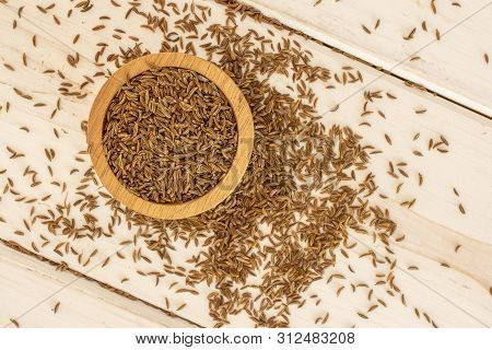 Lot Of Whole Small Dry Caraway Fruits In A Wooden Bowl Flatlay On White Wood