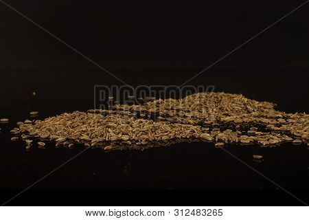 Lot Of Whole Dry Caraway Fruits Isolated On Black Glass