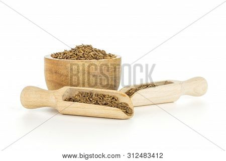 Lot Of Whole Dry Caraway Fruits In A Wooden Bowl And Two Scoops Isolated On White Background