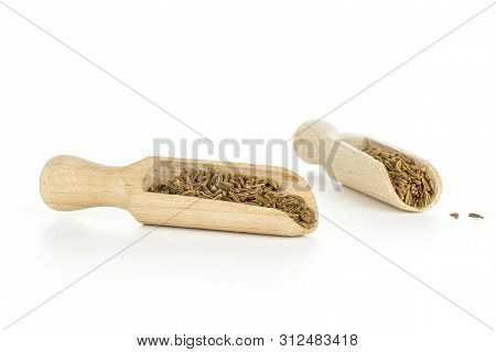 Lot Of Whole Dry Caraway Fruits In Two Wooden Scoops Isolated On White Background