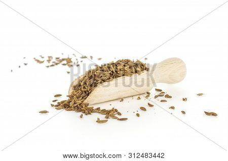 Lot Of Whole Dry Caraway Fruits Closeup With Wooden Scoop Isolated On White Background