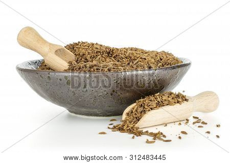 Lot Of Whole Dry Caraway Fruits In A Grey Ceramic Bowl With Two Scoops Isolated On White Background