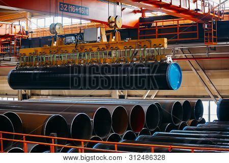 Coated Pipe Transportation By Overhead Crane With Vacuum Handling Grippers.