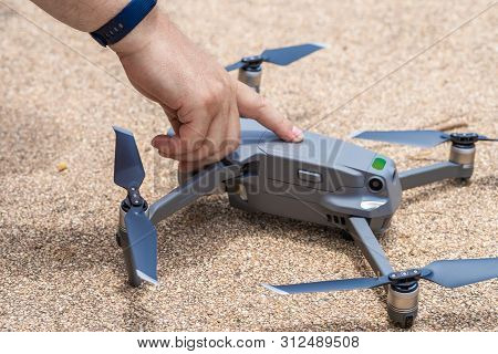 Male Hand Presses The Button To Launch The Drone For Flight, Close-up