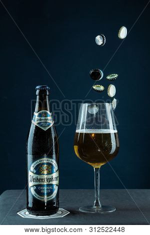 Khabarovsk, Russia - Jul 21, 2018: Beer Bottle Weihenstephan And A Glass Of Beer On Table On Blue Ba