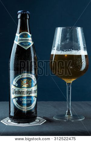 Khabarovsk, Russia - Jul 21, 2018: Beer Bottle Weihenstephan And A Glass Of Beer On Table On Blue Ba