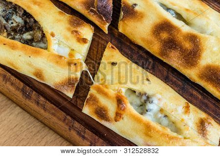 Traditional Turkish Pide At Kebab Restaurant On Wooden Table.