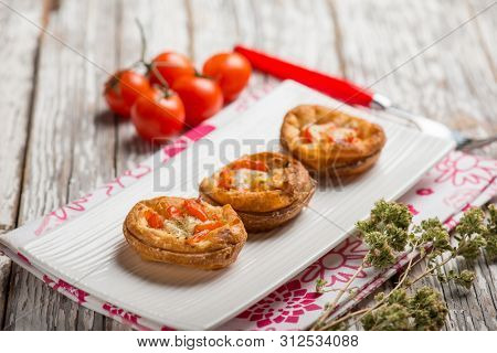 mini pizzas with tomatoes mozzarella and oregano
