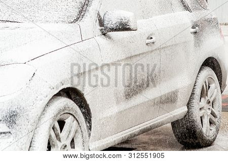 Car Wash With Foam In Car Wash Station. Carwash. Washing Machine At The Station. Car Washing Concept