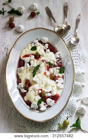 Eton Mess, Traditional English Dessert With Gooseberry, Whipped Cream And Meringue On A Light Backgr