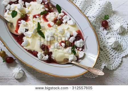 Eton Mess, Traditional English Dessert With Gooseberry, Whipped Cream And Meringue On A Light Backgr
