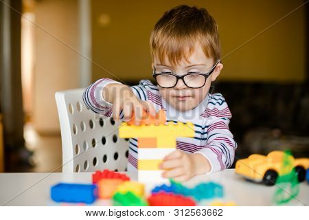 Little Ginger Boy With Glasses With Syndrome Dawn Playing