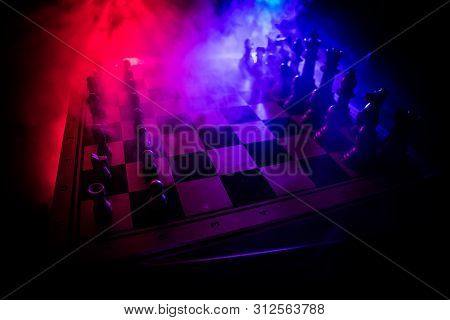 Chess Board Game Concept Of Business Ideas And Competition. Chess Figures On A Dark Background With