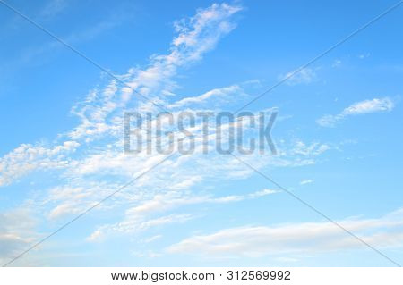 White Translucent Stratus And Cirrus Clouds High In The Blue Summer Sky. Different Cloud Types And A