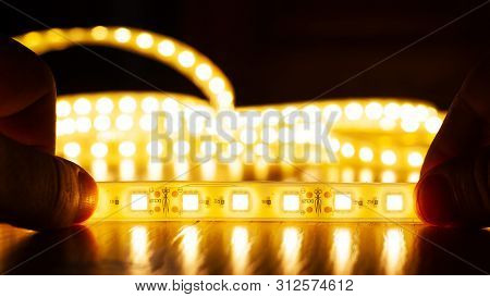 Hands Hold A Led Strip Of A Warm Spectrum, Installation Of Diode Light  Close-up
