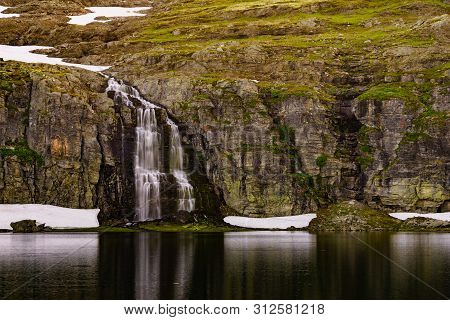 Mountain Lake Flotvatnet With Waterfall. Scenic Region Between Aurland And Laerdal In Norway. Nation