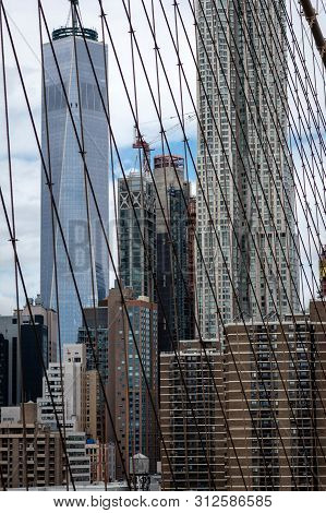 New York, Usa - June 21, 2019:  Manhattan Through The Brooklyn Bridge Metal Ropes.
