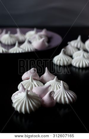 Meringues Laid Out On A Dark Table And In A Plate