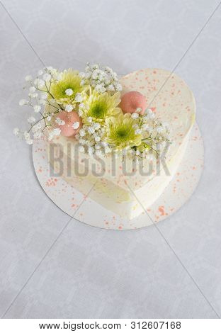 Heart-shaped Cake Decorated With Fresh Flowers And Mousse Balls