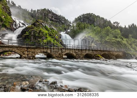 Latefoss Twin Waterfalls Streams Under The Stone Bridge Archs, Odda, Hordaland County, Norway