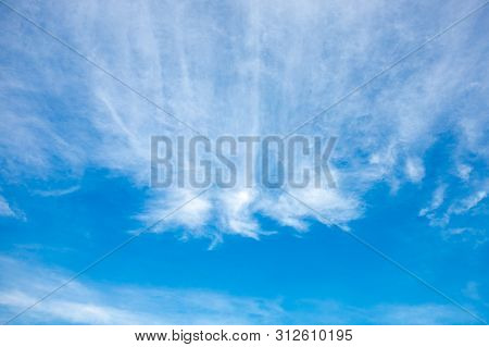 Cirrostratus White Clouds Like A Fire-breathing Dragon On Blue Sunny Sky.