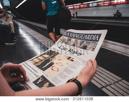 Barcelona - June 1 2018: Woman Reading In Barcelona Metro Station The La Vanguardia Newspaper With T