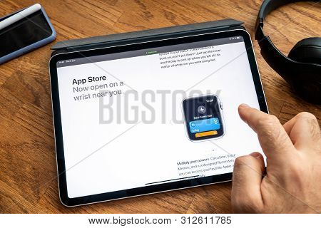 Paris, France - Jun 6, 2019: Man Reading On Apple Ipad Pro Tablet About Latest Announcement Of At Ap