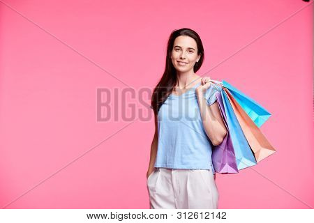 Young pretty shopaholic with shoppng bags
