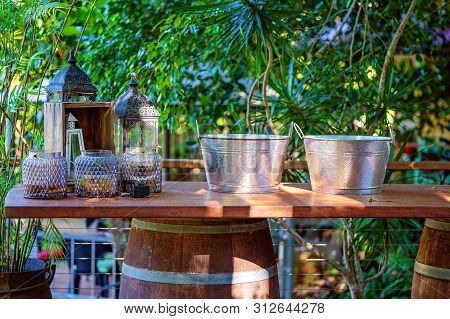 Wine Buckets And Candle Holders On A Wooden Bar Upheld With A Barrel, Bushland Setting