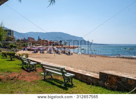 Malia, Crete, Greece - Juni 18, 2019: People Are Resting On A Sunny Day At The Beach In Malia, Crete