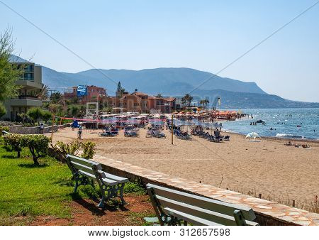 Malia, Crete, Greece - Juni 18, 2019: People Are Resting On A Sunny Day At The Beach In Malia, Crete