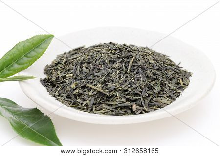 Dried Tea Leaves With Green Tea Leaves On White Background