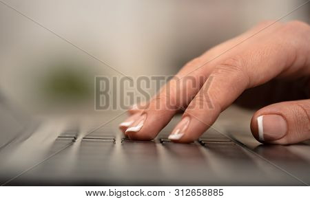 Hand typing on keyboard with office concept